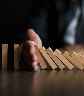 person holding up dominoes