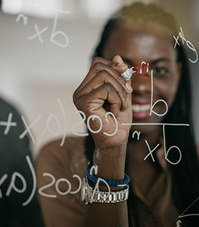 person writing on whiteboard