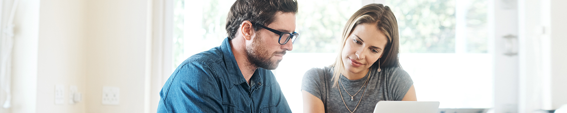 man and woman looking at computer