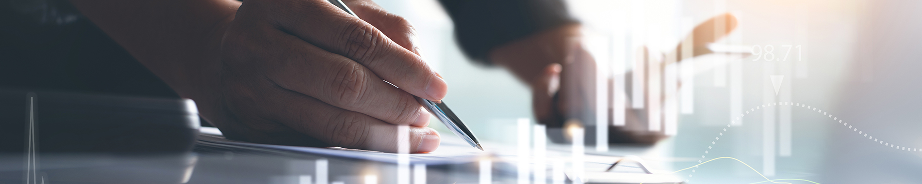 person holding pen with digital chart